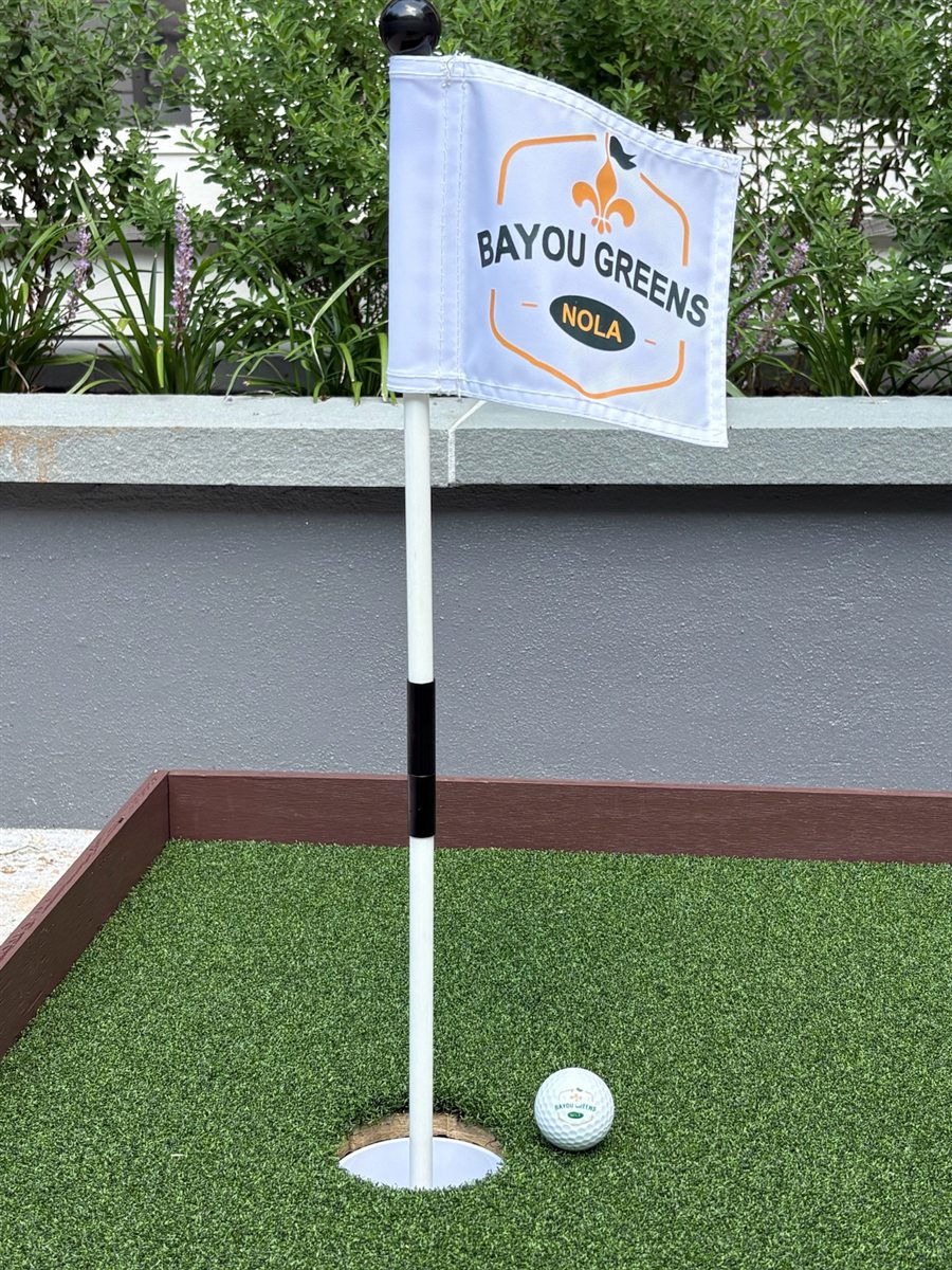 Bayou Greens NOLA branded flag on a putting green