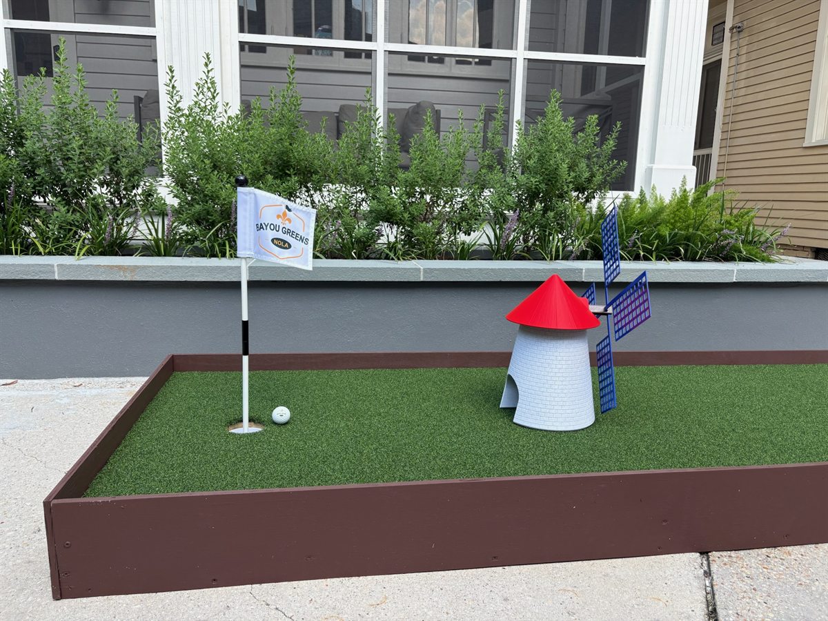 Windmill mini-golf hole with flag