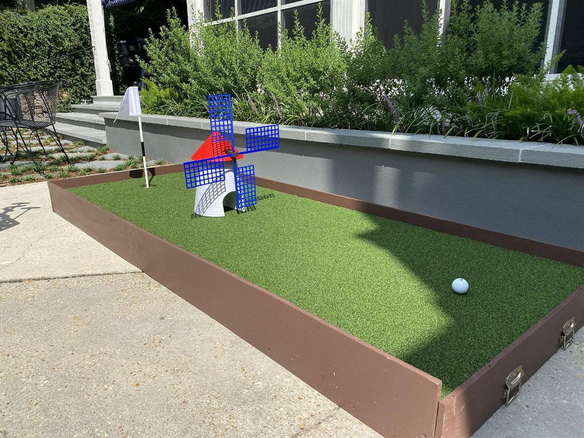 Mini-golf hole with windmill and putting green